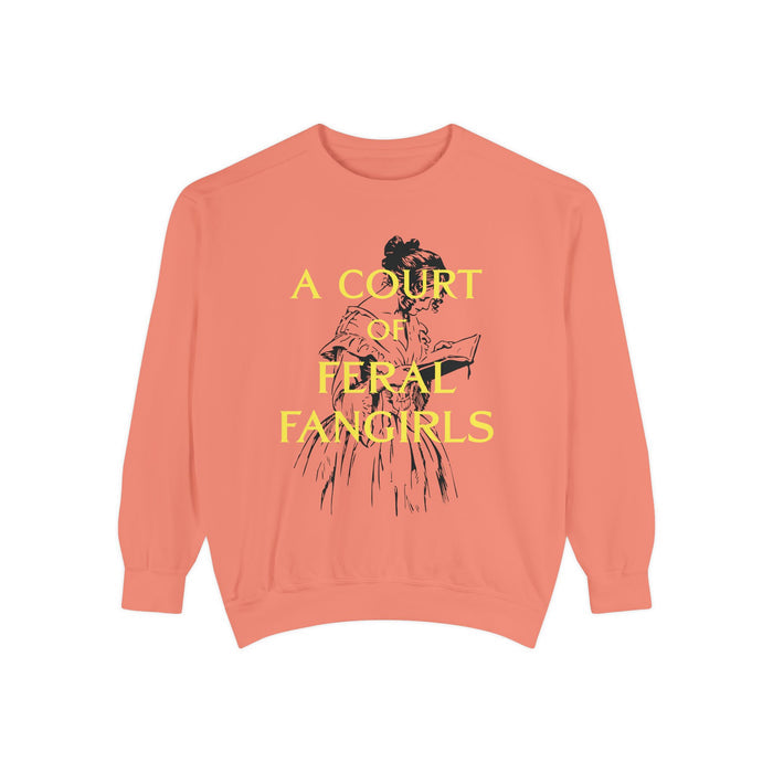 A coral oversized crewneck sweatshirt from thtgrlreads featuring a vintage-style illustration of a woman reading and yellow text "A Court of Feral Fangirls" on soft Comfort Colors fabric, perfect for fans in the Book Bestie and Off Brand collections.