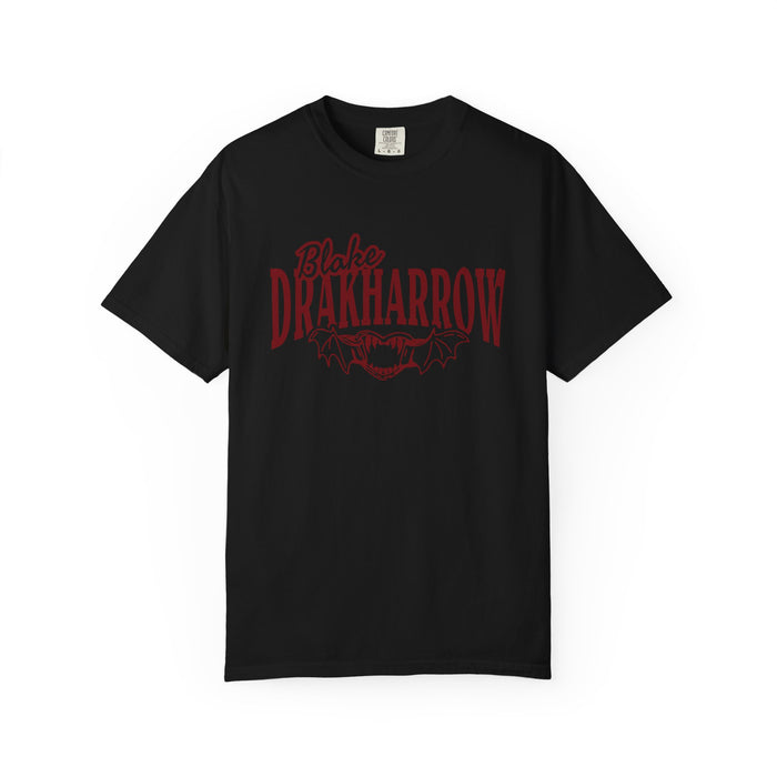 Black Comfort Colors graphic tee from thtgrlreads featuring Bloodwing Academy design with dark red gothic text and bat wings, part of official bookish apparel collections.
