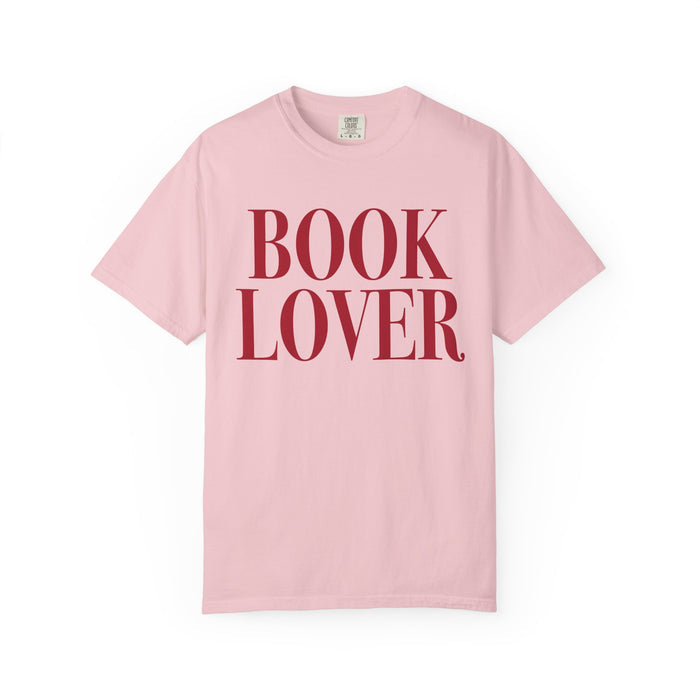 Comfort Colors vintage-washed pink graphic tee from thtgrlreads featuring bold red serif "BOOK LOVER" text, part of the Tees collection for bookish apparel fans.