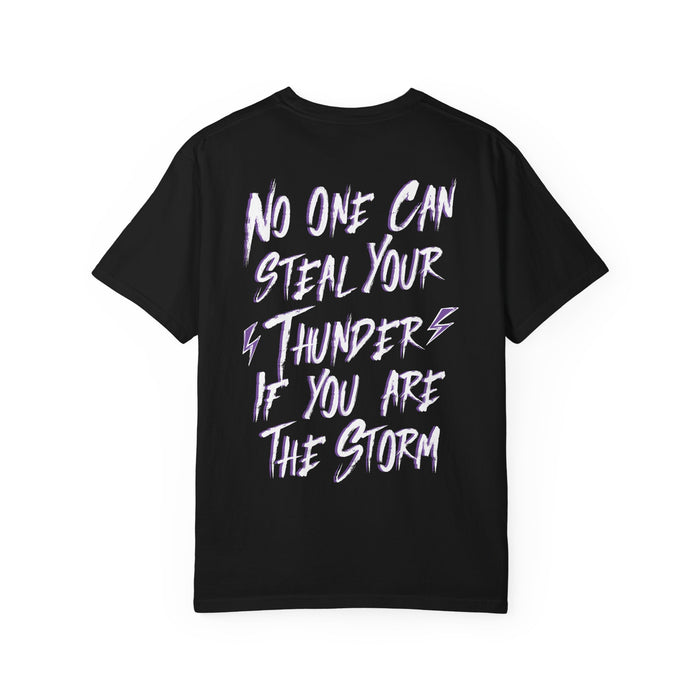 thtgrlreads black Comfort Colors graphic tee featuring a bold white and purple text design that reads "No one can steal your thunder if you are the storm" with lightning bolt accents.