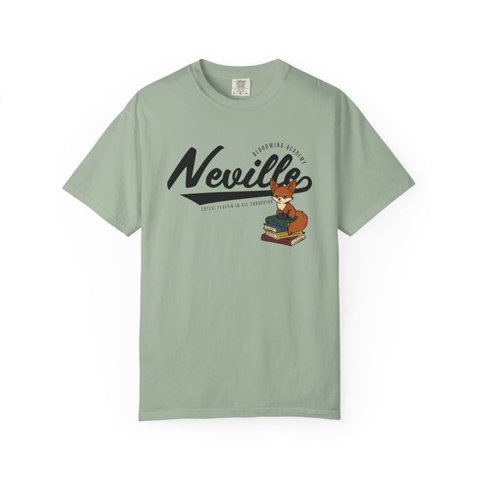 Thtgrlreads Bloodwing Academy collection comfort colors graphic tee featuring vintage wash sage green fabric and a playful fox illustration sitting on stacked books with stylized "Neville" text.