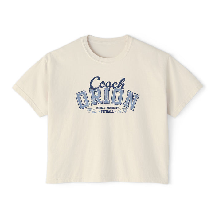 A vintage wash cream comfort colors cropped t-shirt from thtgrlreads featuring a blue collegiate-style "Coach Orion" graphic, part of the Zodiac Academy collection.