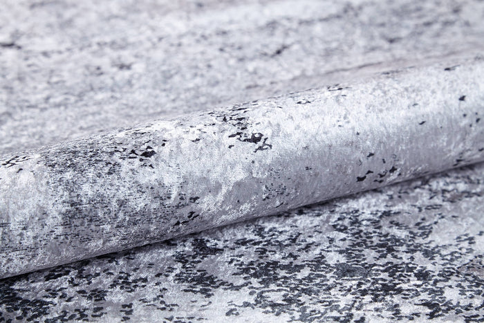 A close-up of textured wallpaper with a metallic silver-gray marbled design and black speckles, a reflective finish, and ideal for pairing with the Techno Flux - Washable Rug - JR1814 to enhance any modern space.