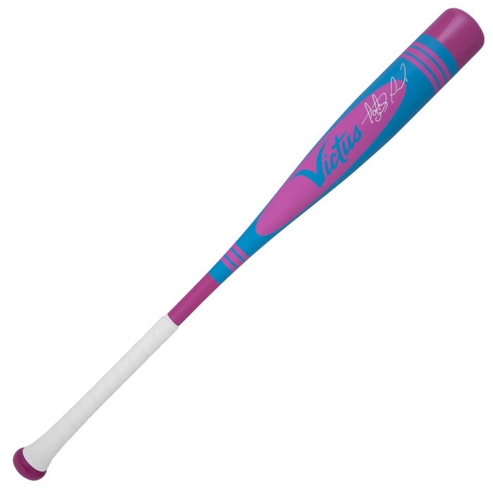 The 2025 Victus Vibe Pro-Crayon Fernando Tatis Jr (-5) 2 3/4" USSSA Baseball Bat features a blue and purple one-piece aluminum design with pink accents, white grip tape, a vibration-reducing knob, and pink "Victus" plus signature.