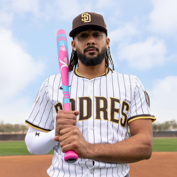A man holding a Victus 2025 Vibe Pro-Crayon Fernando Tatis Jr (-10) 2 3/4" USSSA one-piece aluminum baseball bat.