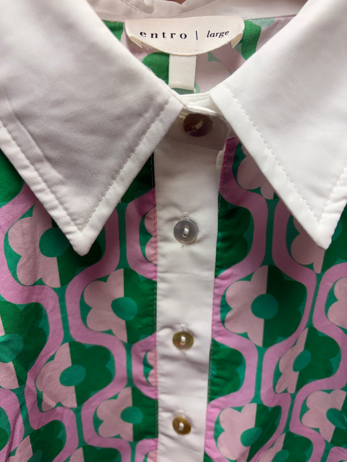 Entro Mod Floral Blouse featuring a vibrant floral pattern and lightweight fabric, displayed on a hanger.