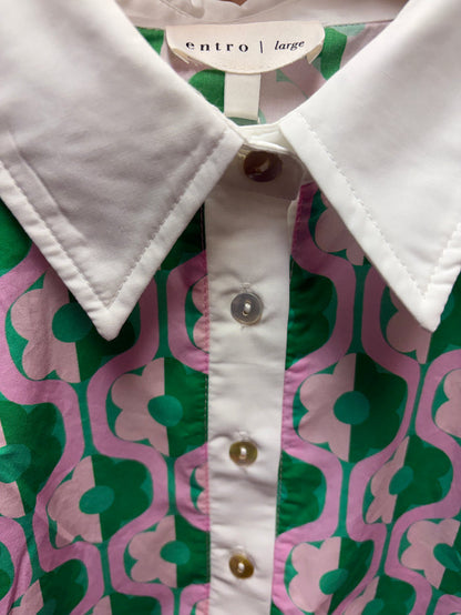 Entro Mod Floral Blouse featuring a vibrant floral pattern and lightweight fabric, displayed on a hanger.