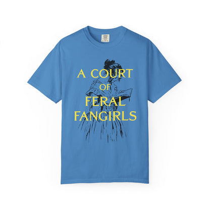 Comfort Colors graphic tee in vintage blue from thtgrlreads featuring a black sketch of a woman reading and bold yellow text "A COURT OF FERAL FANGIRLS" from the Off Brand, Tees, and Book Bestie collections.