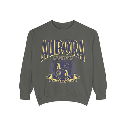 Bloodwing Academy merchandise from thtgrlreads featuring a vintage wash Comfort Colors crewneck sweatshirt with a bold yellow and purple Aurora Academy crest graphic and collegiate-style text.