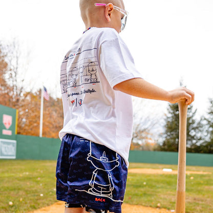 Child holding a baseball bat on a baseball field wearing Pablo Sanchez graphic tee and Pablo Sanchez graphic shorts