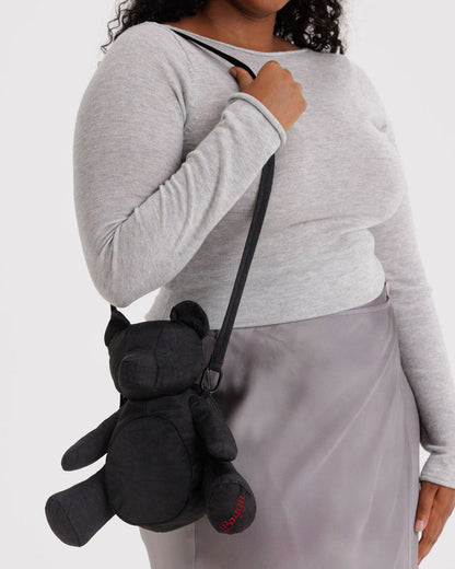 Black plush bear bag worn crossbody, bear face detail and dangling strap