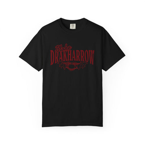 Black Comfort Colors graphic tee from thtgrlreads featuring Bloodwing Academy design with dark red gothic text and bat wings, part of official bookish apparel collections.