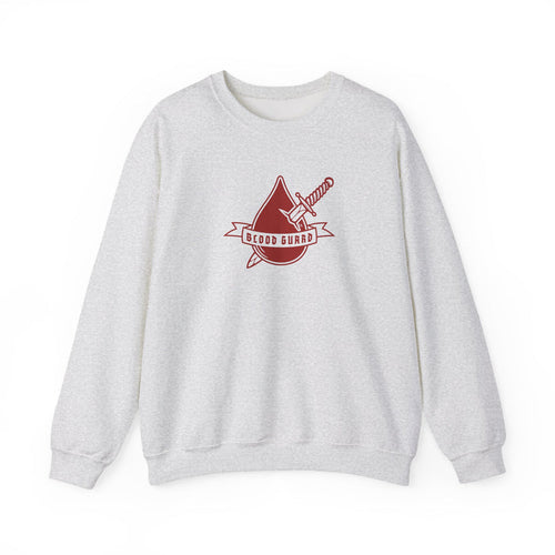 Thtgrlreads Bloodwing Academy crewneck featuring a vintage-washed Comfort Colors fabric with a bold red graphic of a dagger and blood drop with "Blood Guard" text, part of officially licensed bookish apparel collections.