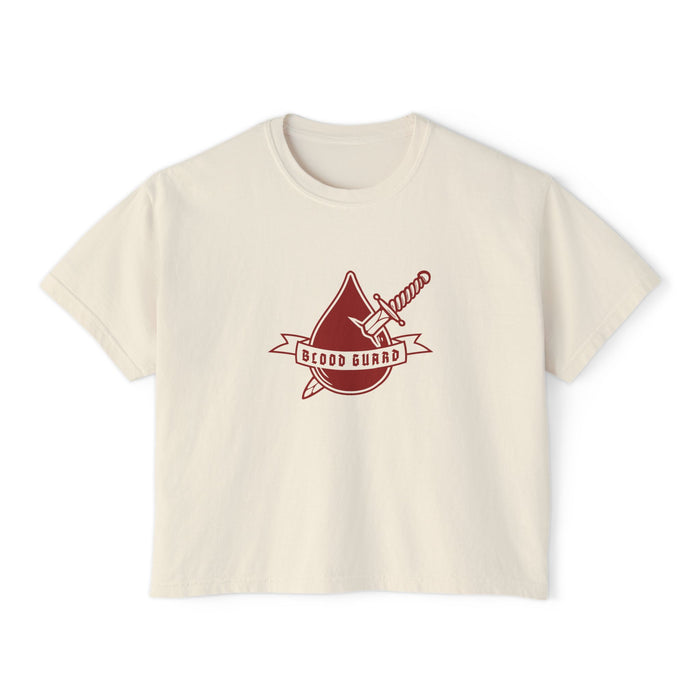 Thtgrlreads Bloodwing Academy crop top featuring a vintage-wash comfort colors fabric with a bold graphic of a blood drop and sword and "Blood Guard" banner in deep red, part of officially licensed bookish apparel collections.