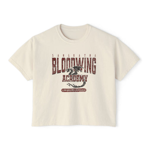Bloodwing Academy crop top from thtgrlreads features a vintage wash Comfort Colors fabric with a distressed dragon graphic and bold Bloodwing Academy text, part of the Tees collection.