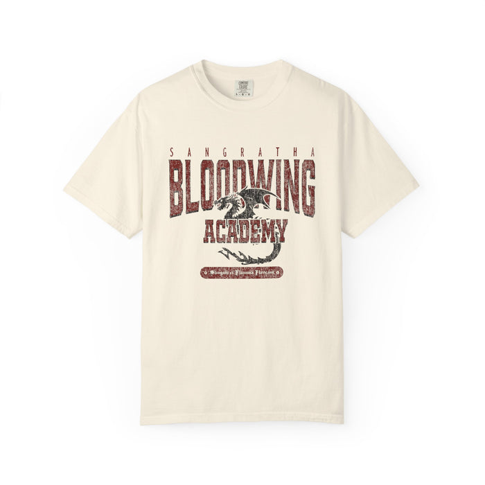 Cream Comfort Colors graphic tee from thtgrlreads featuring a vintage wash Bloodwing Academy design with a distressed dragon print, part of the Back to School and Tees collections.