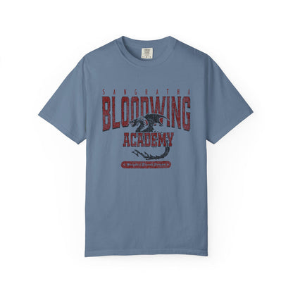 Bloodwing Academy comfort colors graphic tee by thtgrlreads featuring vintage wash soft blue fabric with bold red gothic text and a detailed dragon illustration in the center, part of the Bloodwing Academy and Back to School collections.