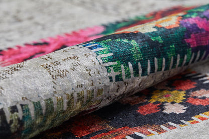 A close-up of the Blooming Paradise - Washable Rug - JR188 shows vibrant geometric and floral patterns in green, pink, red, and black on a textured background—perfect for stylish high-traffic spaces.