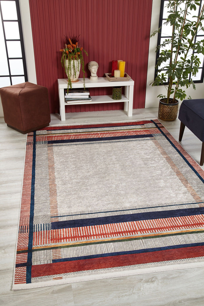 A modern living room with the Bohemian Nightscape - Washable Rug - JR1701, featuring red, navy, and beige stripes—ideal for high-traffic areas—light wood floor, white console table, brown ottoman, blue chair, and plant by a red accent wall.