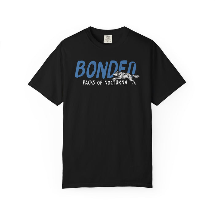 Thtgrlreads Wolves of Ruin collection Comfort Colors graphic tee in black featuring blue and white "Bonded Packs of Nocturna" vintage puff print with wolf illustration, offered by Printify.
