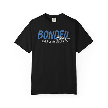 Thtgrlreads Wolves of Ruin collection Comfort Colors graphic tee in black featuring blue and white "Bonded Packs of Nocturna" vintage puff print with wolf illustration, offered by Printify.