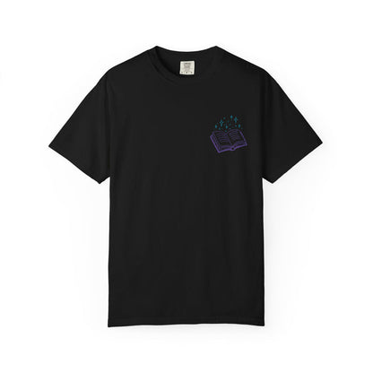 thtgrlreads Book Bestie collection comfort colors graphic tee featuring a small purple open book with teal sparkles print on black unisex vintage wash fabric