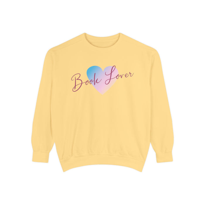 Thtgrlreads cozy oversized crewneck sweatshirt from the Book Bestie collection featuring vintage-washed Comfort Colors fabric and a pastel blue and pink heart with "Book Lover" scripted text.