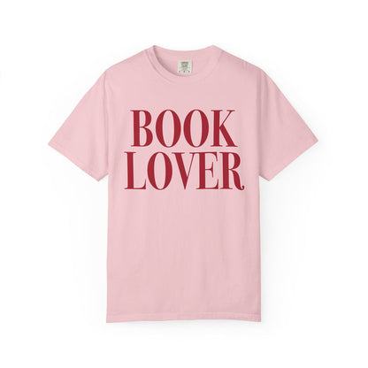 Comfort Colors vintage-washed pink graphic tee from thtgrlreads featuring bold red serif "BOOK LOVER" text, part of the Tees collection for bookish apparel fans.