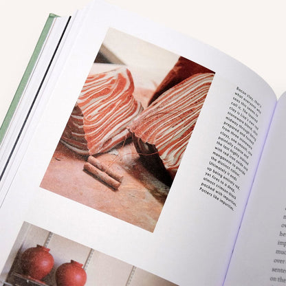 Open pottery book page with photo of hands working on clay
