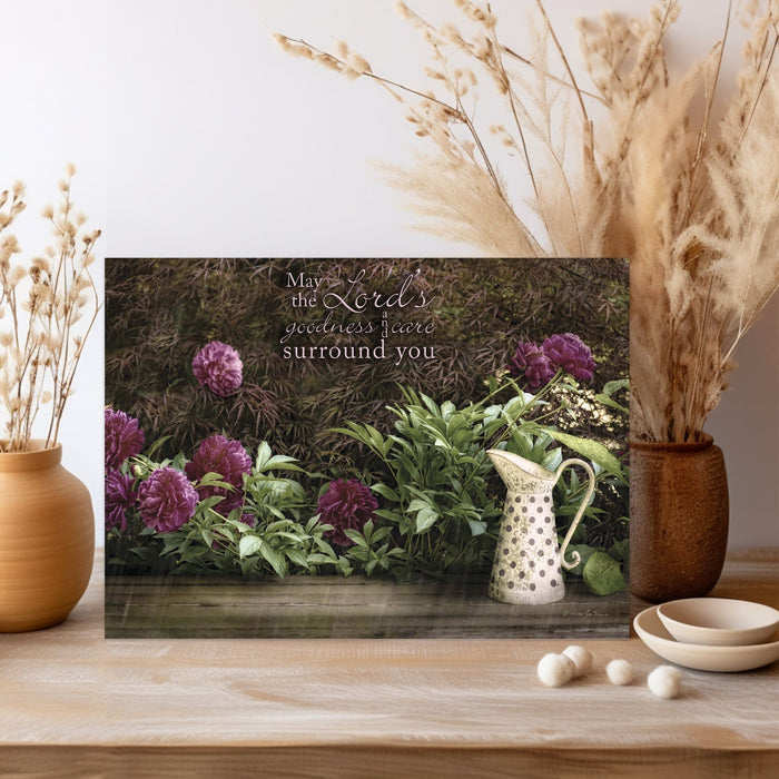 Decorative poster with floral design and inspirational quote on a wooden surface with decorative elements.