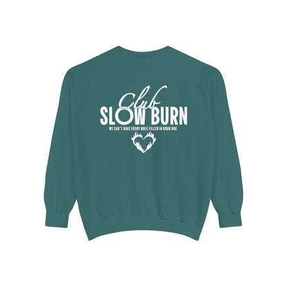A vintage-washed Comfort Colors oversized crewneck sweatshirt in teal featuring white graphic text "Club Slow Burn" and a heart design, officially licensed by thtgrlreads, perfect for Book Bestie and Crewnecks collections.