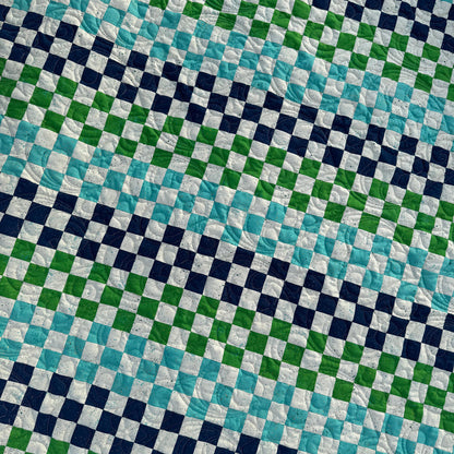 Checkered fabric pattern with blue, green, and white squares