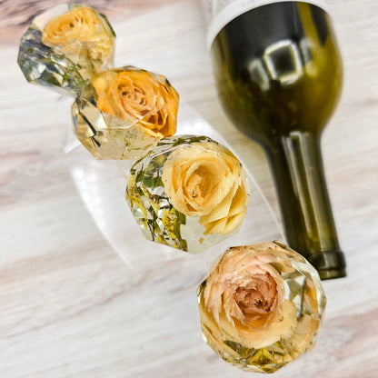 Square close-up of a pressed flower resin product on a light background