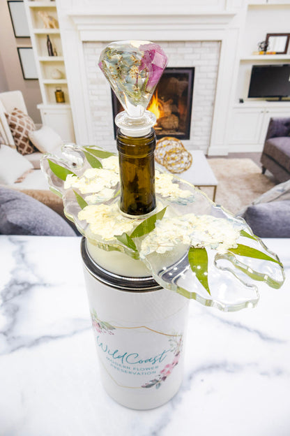 Tall portrait photo of a pressed flower wine stopper with soft dried roses in clear resin