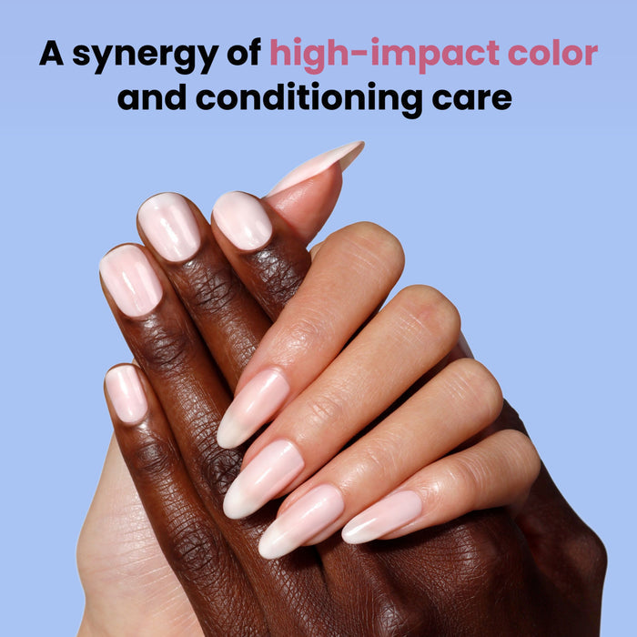 Four hands with creamy light pink nails (shade: Double Scoop by LONDONTOWN) are layered over a blue background. Text above: "A synergy of high-impact color and conditioning care.