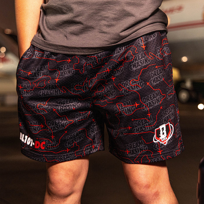 Youth model wearing black Dream Chaser Red Eye youth shorts