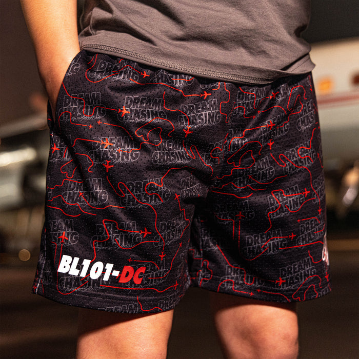 Youth model wearing black Dream Chaser Red Eye youth shorts