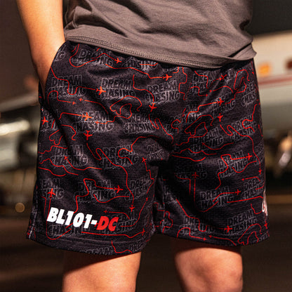 Youth model wearing black Dream Chaser Red Eye youth shorts
