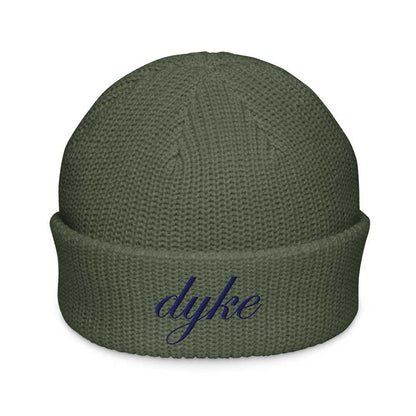 Green beanie with 'dyke' embroidered on a white background