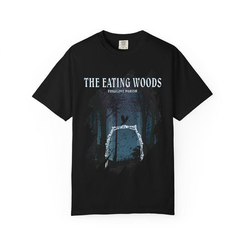 Thtgrlreads Comfort Colors graphic tee from The Eating Woods collection featuring a vintage wash black tee with a forest arch design and white text reading "The Eating Woods Foxglove Parish.