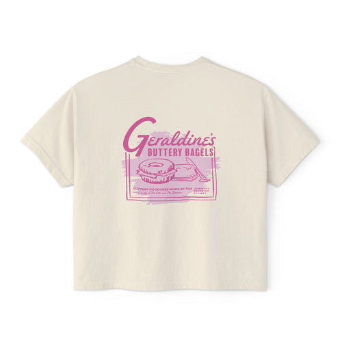 thtgrlreads Zodiac Academy collection features a cream-colored Comfort Colors cropped t-shirt from Printify with a vintage-style pink graphic of bagels and retro text inspired by Geraldine’s Buttery Bagels.