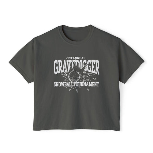 Liv Zander collection crop top from thtgrlreads featuring a vintage-wash Comfort Colors fabric with a bold white graphic reading "1st Annual Gravedigger Snowball Tournament" on a charcoal gray unisex cropped t-shirt.