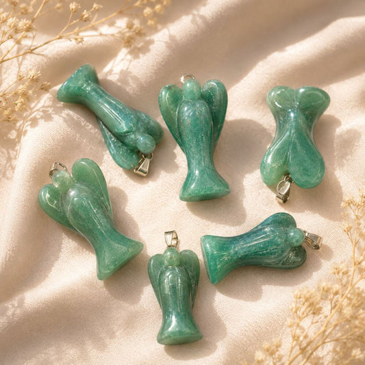 Green Aventurine angel crystal pendants with silver bails on a neutral textured background.