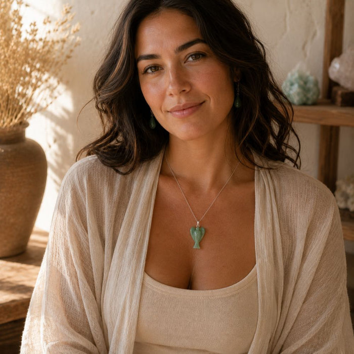 Woman wearing a Green Aventurine angel pendant necklace with a casual neutral outfit.