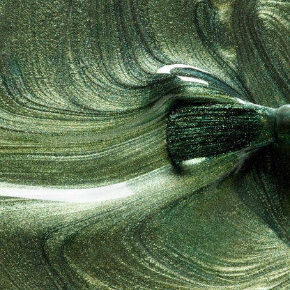 A close-up shows a brush applying Manucurist’s Groove metallic green gel polish, creating glossy, swirling patterns and vibrant, metallic textures on the surface.