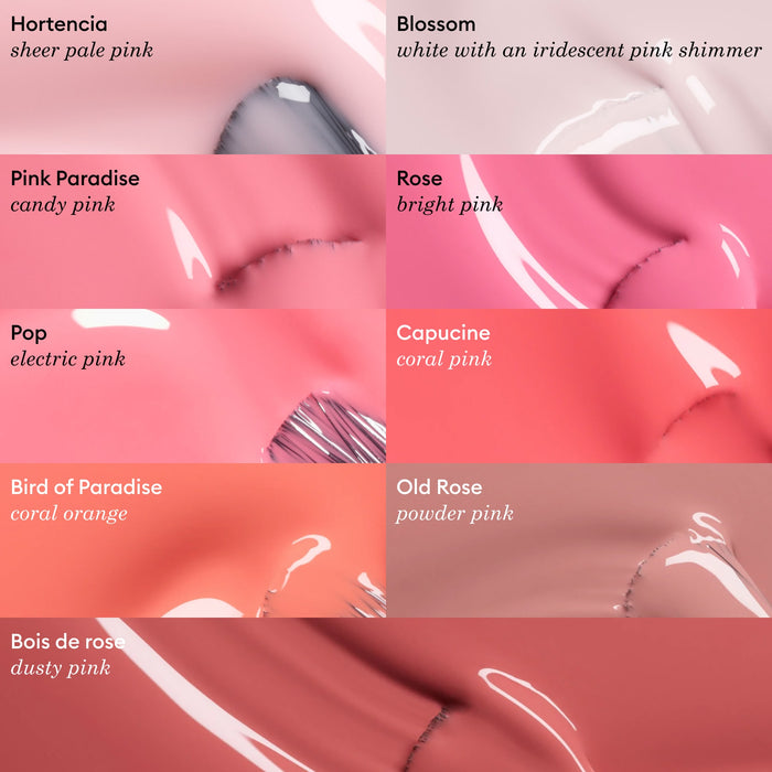 Manucurist's Blossom features nine glossy, opaque creamy nail polishes labeled with names and descriptions, showcasing a gradient of pale pinks, corals, bright pinks, and oranges against a soft background.