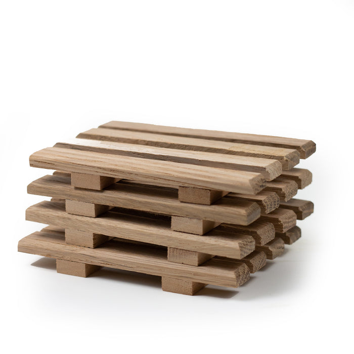 A set of four Handmade Natural Wood Coasters stacked on top of each other.