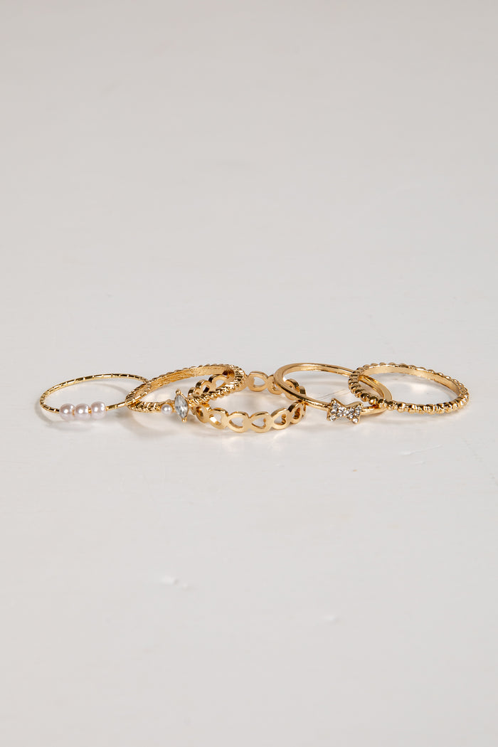 Set of gold rings on a light gray background