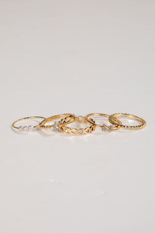 Set of gold rings on a light gray background