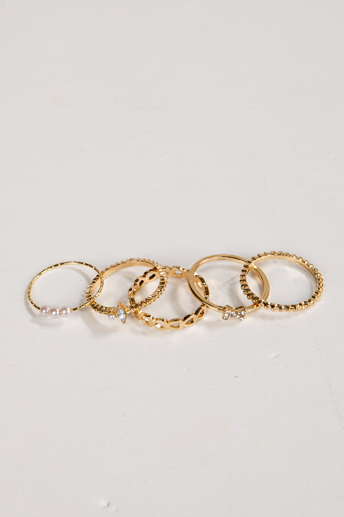 Set of gold rings on a light gray background